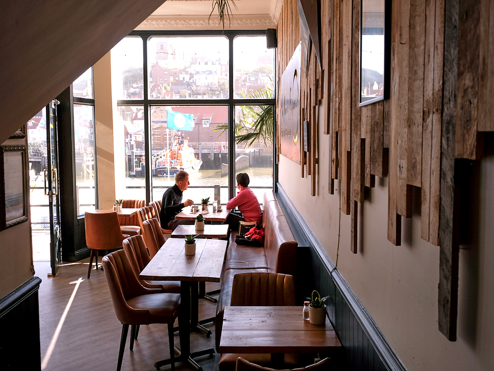 Guests dining beside the windows